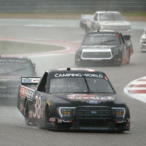 Todd Gilliland (38) won the first stage and ultimately the race after overcoming an early race penalty in the Toyota Tundra 225 at Circuit of The Americas Saturday near Austin, Texas. The race started in the rain and teams used wet weather tires throughout the entire 41-lap race around the 3.41-mile, 20-turn road course. 