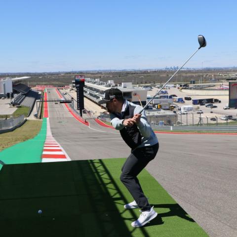 NASCAR Cup Series driver Ricky Stenhouse Jr. tees off from turn one at Circuit of The Americas (COTA) Tuesday as part of "Drive Time," a cross-promotional event between NASCAR at COTA and the PGA TOUR's Dell Technologies Match Play, both being hosted in Austin, Texas this weekend.