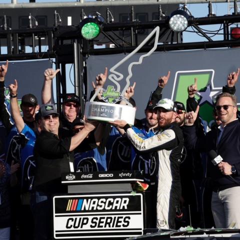 EchoPark Automotive CEO David Smith (left) and Speedway Motorsports President and CEO Marcus Smith (right) present the trophy to Ross Chastain after he captured his first career NASCAR Cup Series win, and the first for Trackhouse Racing, when he took the checkered flag at Sunday's EchoPark Automotive Grand Prix.