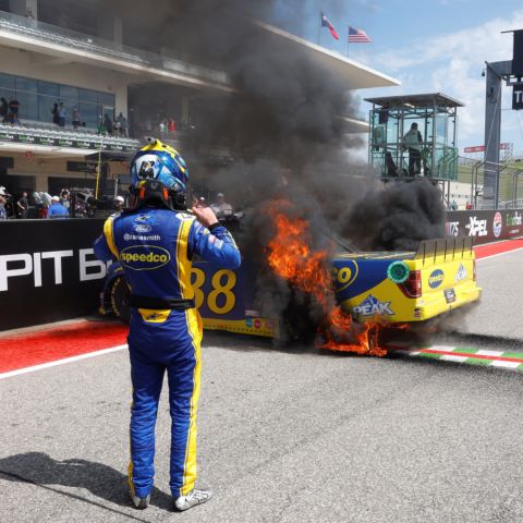 Zane Smith watches as his No. 38 Front Row Motorsports truck is engulfed in flames in Victory Lane after winning the XPEL 225 at Circuit of The Americas on Saturday, March 25, 2023 in Austin, Texas.